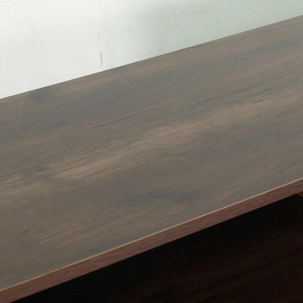 Close-up of a dark brown wood grain furniture surface