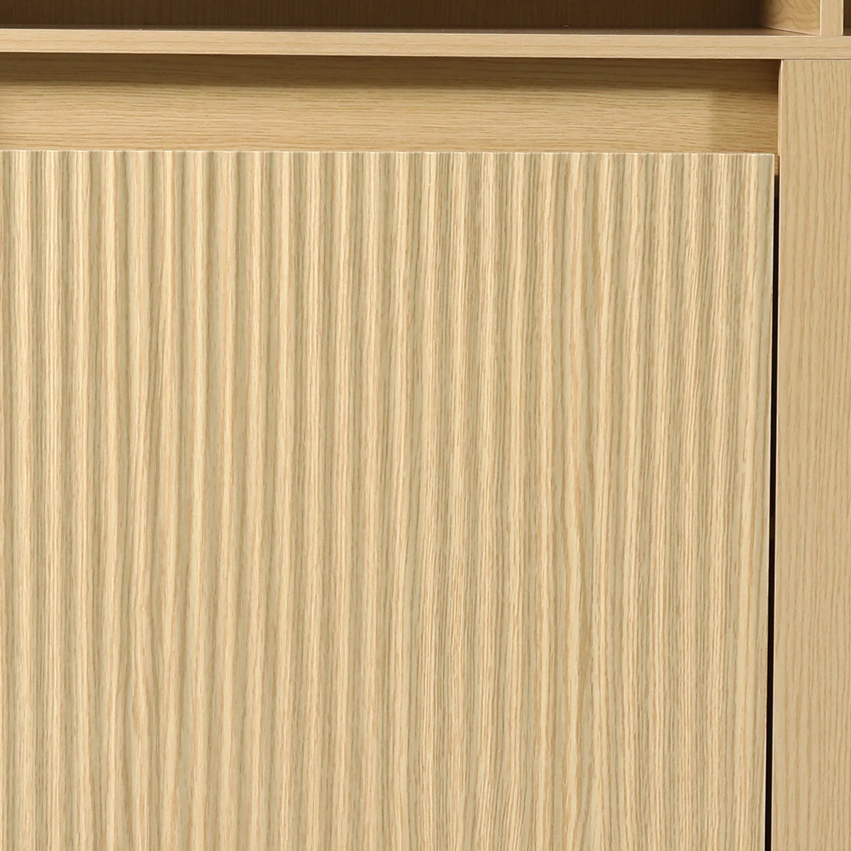 Close-up of light wood furniture with a vertical fluted texture design.