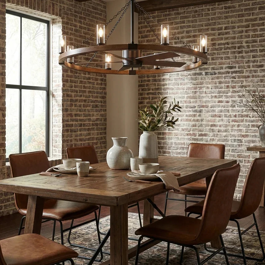 Dining room with wooden table, chairs, and a chandelier in front of a brick wall.
